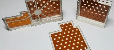 Kapton film adhered to underside of Laird board level shields