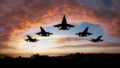 Silhouette if five F18 Fighter Jets at sun set.