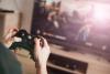 Hands holding xbox controller playing game